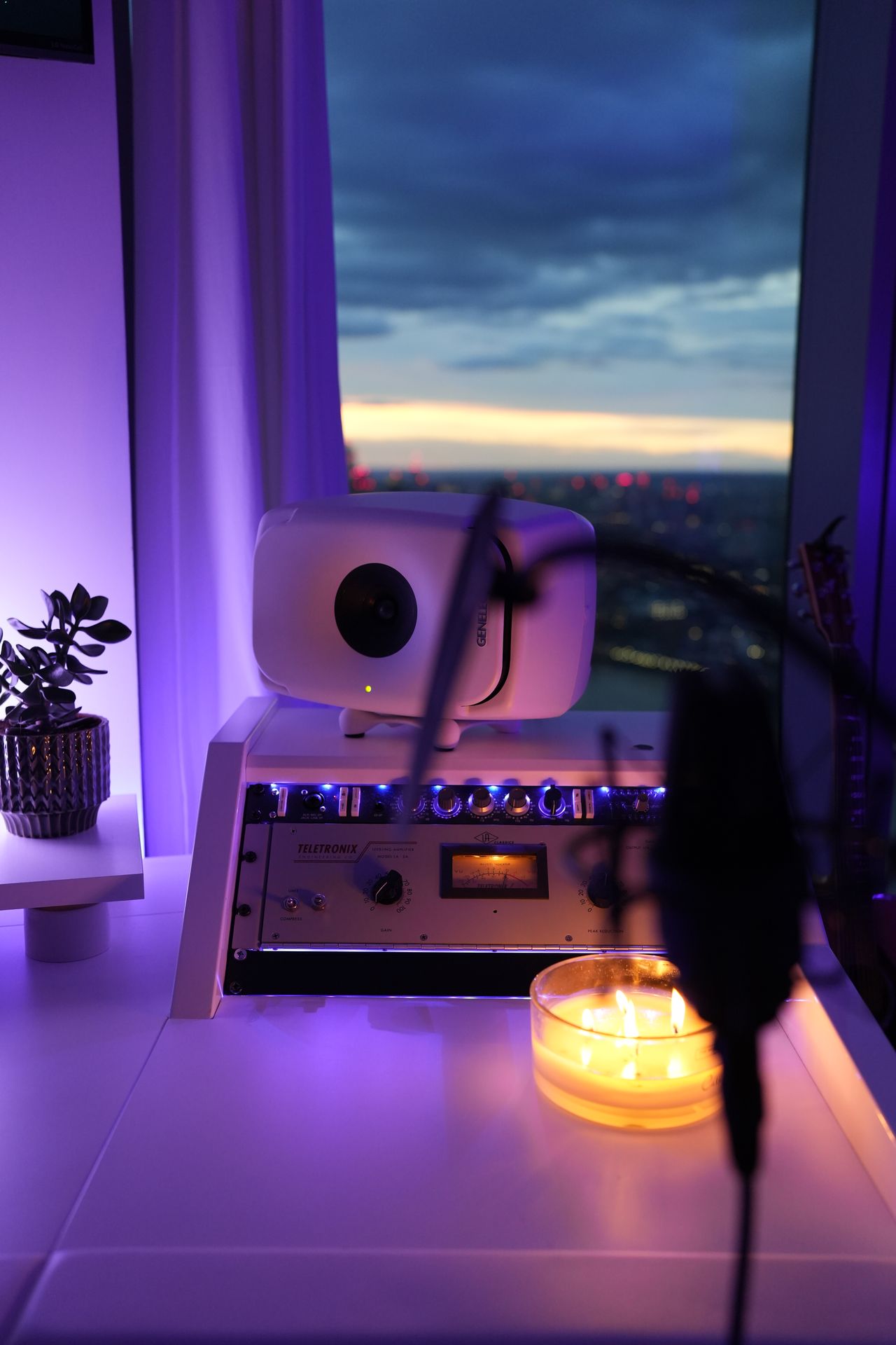 Universal Audio Teletronix outboard and Genelec monitor overlooking the London skyline at dusk