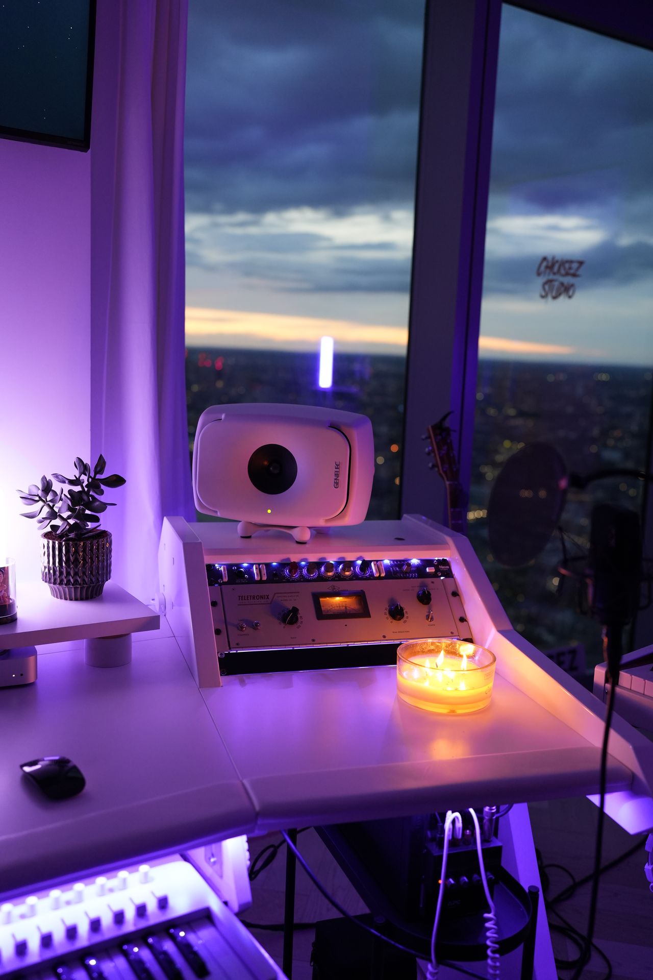 Outboard compressor and studio monitor with London city lights behind